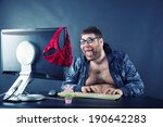 Man sitting at desk looking on computer screen