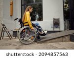 Small photo of A female student in wheelchair at the ramp