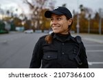 Portrait of smiling police woman on street