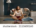Small photo of Funny fatty man meditating practicing home yoga