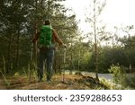 Mature man backpacker enjoying life trekking to explore outdoors