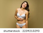 Happy mexican woman in white underwear laughing and having fun with body acceptance and self love 