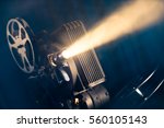 film projector on a wooden background with dramatic lighting and selective focus