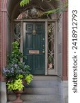Small photo of Nature-inspired green door, sidelights, and transom window create an inviting blend of light and style.