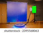 Defocused view of a 360 photo booth used at an event. Banner and TV green screen.