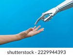 Human hand touching robot finger.