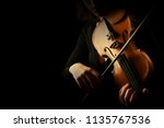 Violin player. Violinist hands playing violin orchestra musical instrument closeup