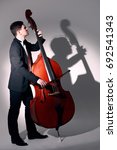 Small photo of Double bass player playing contrabass Jazz musician
