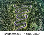 Winding road from the high mountain pass in Transylvania, Romania. Great road trip trough the dense woods. Aerial view.