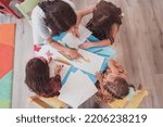 Small photo of Creative kids during an art class in a daycare center or elementary school classroom drawing with female teacher.
