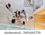 Small photo of Top view of a Muslim family joyously comes together around a table, eagerly awaiting the communal iftar, engaging in the preparation of a shared meal, and uniting in anticipation of a collective