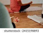 In this sunlit space, a senior woman's hand gracefully engages in various yoga poses, embodying the essence of active aging, health, and inner peace