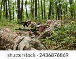 Small photo of Elite soldiers stealthily maneuver through the dense forest, camouflaged in specialized gear, as they embark on a covert and strategic military mission