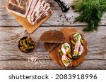 bacon with rye bread and pickles on a wooden background