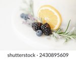 closeup of berries lemon rosemary cake garnish