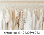 delicate rack of neutral dresses on gold hangers