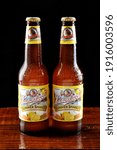 Small photo of IRVINE, CALIFORNIA - 18 JUNE 2015: Two bottles of Leinenkugel Summer Shandy beer on a wet bar countertop.