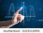 Small photo of Close up of business man hand pointing at abstract glowing mathematical formula graph on blue background. Equation, digital data and mathematics app concept