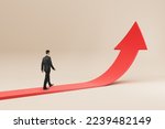 Business success, growth and personal development concept with businessman back view walking on red arrow growing up on abstract light background