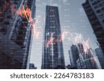 Investing and real estate market crash concept with falling down digital financial chart candlestick and graphs with data indicators on city modern business centers background, double exposure