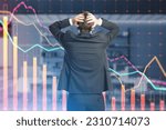 Small photo of Back view of thoughful european businessman with downward red crisis chart grid on blurry office interior background. Recession and economic fall concept. Double exposure