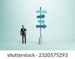 Small photo of Right choice, dilemma and business strategy direction concept with pensive man in black suit looking at signpost with blue arrows in different direction on abstract light background