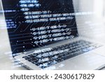 Small photo of A modern laptop displaying HTML coding language on the screen with graphical user interface elements superimposed