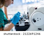 Small photo of Laboratory assistant works on a rotary microtome section and making microscope slides