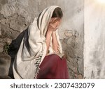 Small photo of Misery lost feel mourn weep mood young lone holy jew maid slave teen lady Mary sit ask god Jesus Christ faith hope. Old retro roman history biblical adult human shame abuse white islam home text space
