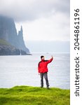 a tourist in a red jacket takes ... | Shutterstock . vector #2044861196