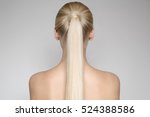 Portrait Of A Beautiful Young Blond Woman With Ponytail Hairsty?le. Back view