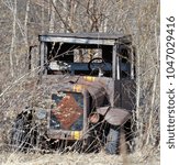 Small photo of Antique truck left to waste away in the weeds