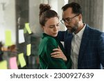 Small photo of Mature man abusing his younger colleague, concept of harassment at workplace.