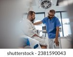 Small photo of Supportive doctor soothing a worried overweight patient, discussing test result in emergency room. Illnesses and diseases in middle-aged men's health. Compassionate physician supporting stressed