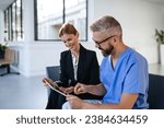 Small photo of Pharmaceutical sales representative talking with doctor in medical building. Ambitious female sales representative presenting new medication. Woman business leader.