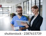 Small photo of Pharmaceutical sales representative talking with doctor in medical building. Ambitious female sales representative presenting new medication. Woman business leader.