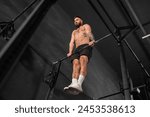 Strong man performing muscle up ...
