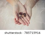 woman hands in wedding dress holding acorns