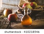 Apple vinegar. Bottle of apple organic vinegar on wooden background. Healthy organic food.