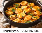 Small photo of Hot delicious Spanish potatoes in a spicy sauce Patatas a la importancia close-up in a frying pan on the table. horizontal