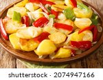 Small photo of Spanish Patatas a lo Pobre Poor Man's Potatoes close up in the plate on the table. Horizontal