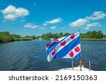 Cruising through National Park Alde Feanen in Friesland the Netherlands with the frisian flag