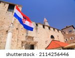 Trogir town walls and flag of Croatia. Architecture of Trogir, Croatia.
