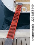 Small photo of Sailing in Split, Croatia. Sailing yacht wooden boarding gangplank walking bridge (passerelle) mounted to the stern of the boat in a marina.