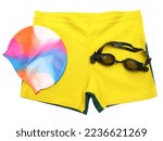Isolated swimmer’s accessories, includes swimming shorts, multicolor cap, goggles.