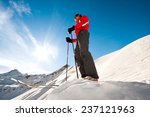 Young man on top of a mountain ready for skiing