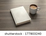 Photo blank book cover on textured wood background with cape of coffee