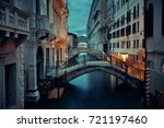 Venice canal view at night with bridge and historical buildings. Italy.