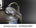 Small photo of brand new stainless steel alcohol machine or moonshine still on black background.