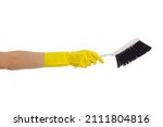 housekeeping concept - hand in yellow rubber glove holding plastic brush isolated on white background